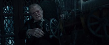 Movie still from “The House with a Clock in Its Walls” (2018), directed by Eli Roth – An old man in a suit and tie looking out of a car window; Close Up shot, High angle