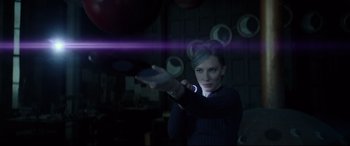 Movie still from “The House with a Clock in Its Walls” (2018), directed by Eli Roth – A woman holding a remote control in her hand; Medium shot, Over the shoulder angle