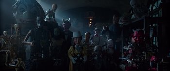 Movie still from “The House with a Clock in Its Walls” (2018), directed by Eli Roth – A group of people in a dark room with masks on; Wide shot, Low angle