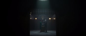 Movie still from “The House with a Clock in Its Walls” (2018), directed by Eli Roth – Two women and a man are standing in a dark room; Wide shot, Over the shoulder angle