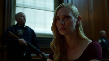 Movie still from “Daredevil” (2015), created by Drew Goddard – A woman with long blonde hair is looking to her left; Close Up shot, Over the shoulder angle