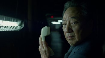 Movie still from “Daredevil” (2015), created by Drew Goddard – An older man holding a phone in a dark room; Close Up shot, Low angle