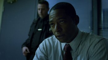 Movie still from “Daredevil” (2015), created by Drew Goddard – A man in a suit and tie sitting next to another man in a suit and tie; Close Up shot, Over the shoulder angle
