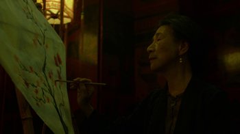 Movie still from “Daredevil” (2015), created by Drew Goddard – An older woman is painting a picture on a canvas; Close Up shot, Low angle