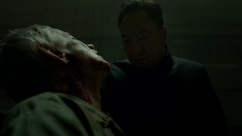 Movie still from “Daredevil” (2015), created by Drew Goddard – An asian man looking at a man's face with blood on it; Close Up shot, Over the shoulder angle