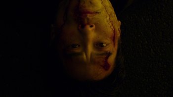 Movie still from “Daredevil” (2015), created by Drew Goddard – A person's face covered in blood; Extreme Close Up shot, Overhead angle