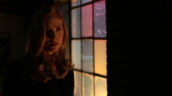 Movie still from “Daredevil” (2015), created by Drew Goddard – A woman standing in front of a stained glass window; Close Up shot, Over the shoulder angle
