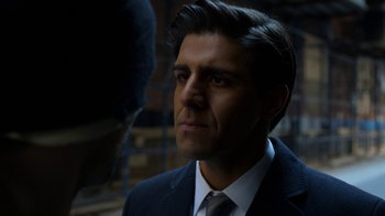 Movie still from “Daredevil” (2015), created by Drew Goddard – A person wearing a suit and tie; Close Up shot, Over the shoulder angle