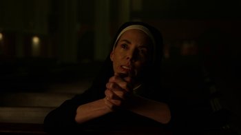 Movie still from “Daredevil” (2015), created by Drew Goddard – A woman in a nun's habit sitting in a dark room; Close Up shot, Low angle
