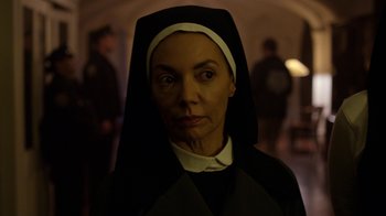 Movie still from “Daredevil” (2015), created by Drew Goddard – A woman wearing a nun's outfit in the dark; Close Up shot, Low angle