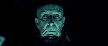 Movie still from “Dark City” (1998), directed by Alex Proyas – An old man's face is lit up in the dark; Close Up shot, Over the shoulder angle