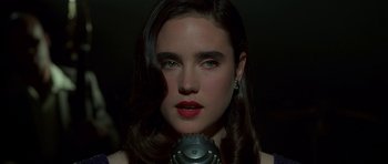 Movie still from “Dark City” (1998), directed by Alex Proyas – A person holding a microphone; Close Up shot, High angle