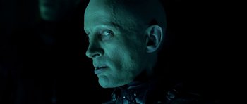 Movie still from “Dark City” (1998), directed by Alex Proyas – A man with a bald head wearing a leather jacket; Close Up shot, Low angle
