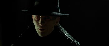 Movie still from “Dark City” (1998), directed by Alex Proyas – A person wearing a hat; Close Up shot, Low angle