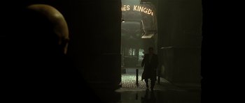 Movie still from “Dark City” (1998), directed by Alex Proyas – A man walking down a dark alley way; Wide shot, Low angle