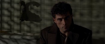 Movie still from “Dark City” (1998), directed by Alex Proyas – A person wearing a jacket; Close Up shot, Low angle