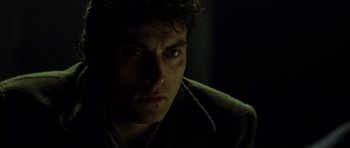 Movie still from “Dark City” (1998), directed by Alex Proyas – A man's face in the dark; Close Up shot, Over the shoulder angle
