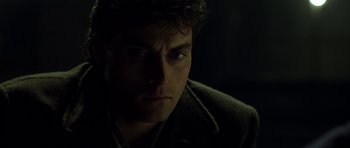 Movie still from “Dark City” (1998), directed by Alex Proyas – A person wearing a jacket; Close Up shot, Over the shoulder angle