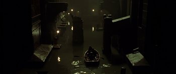 Movie still from “Dark City” (1998), directed by Alex Proyas – A man is in a boat in the water; Extreme Wide shot, High angle