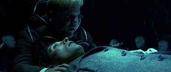 Movie still from “Dark City” (1998), directed by Alex Proyas – A man and a woman are looking at each other in the dark; Close Up shot, High angle