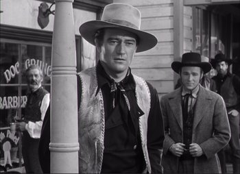 Movie still from “Dark Command” (1940), directed by Raoul Walsh – A black and white photo of a man wearing a hat; Medium shot, Low angle