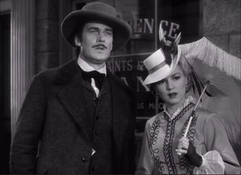 Movie still from “Dark Command” (1940), directed by Raoul Walsh – A man and a woman dressed in old time clothing; Medium shot, Low angle