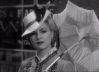 Movie still from “Dark Command” (1940), directed by Raoul Walsh – A black and white photo of a woman holding an umbrella; Close Up shot, Low angle