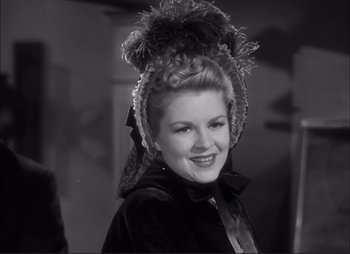 Movie still from “Dark Command” (1940), directed by Raoul Walsh – A black and white photo of a woman wearing a hat; Close Up shot, Low angle