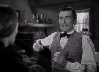 Movie still from “Dark Command” (1940), directed by Raoul Walsh – A black and white photo of a man sitting in a chair; Medium shot, Over the shoulder angle