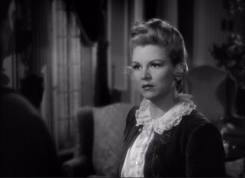 Movie still from “Dark Command” (1940), directed by Raoul Walsh – An old photo of a woman in a black and white photo; Close Up shot, Over the shoulder angle