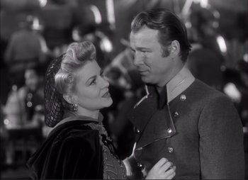 Movie still from “Dark Command” (1940), directed by Raoul Walsh – A man and a woman standing next to each other; Close Up shot, Low angle