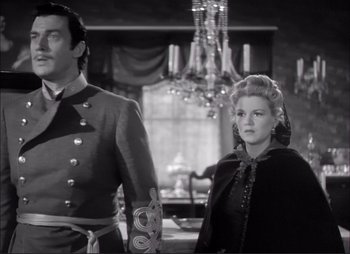 A man and a woman standing next to each other in a room