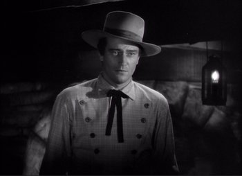 Movie still from “Dark Command” (1940), directed by Raoul Walsh – A black and white photo of a man wearing a hat; Medium shot, Low angle