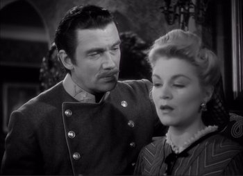 Movie still from “Dark Command” (1940), directed by Raoul Walsh – A black and white photo of a man and a woman; Medium shot, Low angle