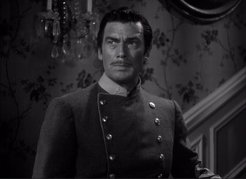 Movie still from “Dark Command” (1940), directed by Raoul Walsh – Black and white photograph of a man in a military uniform; Close Up shot, Low angle