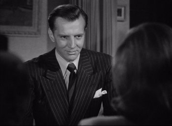 Movie still from “Dark Passage” (1947), directed by Delmer Daves – A man wearing a suit and tie looking at a mirror; Close Up shot, Over the shoulder angle