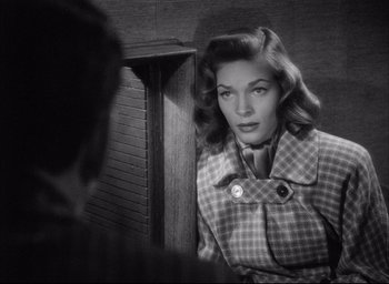 Movie still from “Dark Passage” (1947), directed by Delmer Daves – A black - and - white photo of a woman looking at herself in the mirror; Close Up shot, Over the shoulder angle