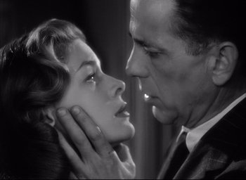 Movie still from “Dark Passage” (1947), directed by Delmer Daves – A man and a woman face to face in a black and white photo; Close Up shot, Low angle