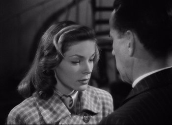 Movie still from “Dark Passage” (1947), directed by Delmer Daves – An old photo of a man and a woman talking to each other; Close Up shot, Over the shoulder angle