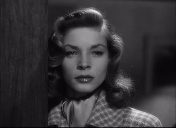 Movie still from “Dark Passage” (1947), directed by Delmer Daves – A black - and - white photo of a woman in a checkered jacket; Close Up shot, Low angle