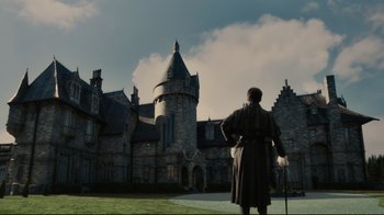 Movie still from “Dark Shadows” (2012), directed by Tim Burton – A man standing in front of an old castle; Extreme Wide shot, Low angle