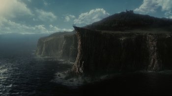 Movie still from “Dark Shadows” (2012), directed by Tim Burton – A man standing on top of a cliff next to a body of water; Extreme Wide shot, High angle
