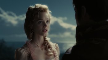 Movie still from “Dark Shadows” (2012), directed by Tim Burton – A young woman in a pink dress looking at a young man; Close Up shot, Over the shoulder angle