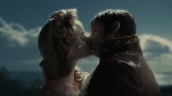 Movie still from “Dark Shadows” (2012), directed by Tim Burton – A man and a woman kissing each other in front of a sky background; Close Up shot, Low angle