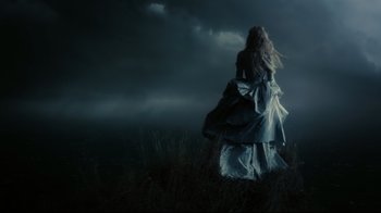 Movie still from “Dark Shadows” (2012), directed by Tim Burton – A woman in a long dress walking in a field; Wide shot, Low angle