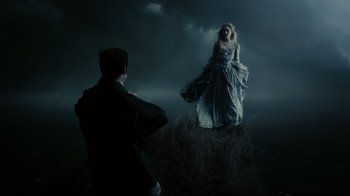 Movie still from “Dark Shadows” (2012), directed by Tim Burton – A man and a woman are standing in a field; Wide shot, Over the shoulder angle