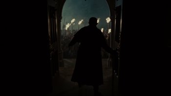 Movie still from “Dark Shadows” (2012), directed by Tim Burton – A man in a black coat is standing in front of a crowd; Wide shot, Low angle