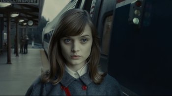 Movie still from “Dark Shadows” (2012), directed by Tim Burton – A woman with long brown hair wearing a gray coat; Close Up shot, High angle