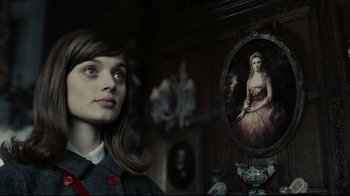 Movie still from “Dark Shadows” (2012), directed by Tim Burton – A woman standing in front of a painting of a woman; Close Up shot, Over the shoulder angle