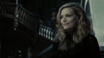 Movie still from “Dark Shadows” (2012), directed by Tim Burton – A woman in a black dress standing in front of a staircase; Close Up shot, Low angle
